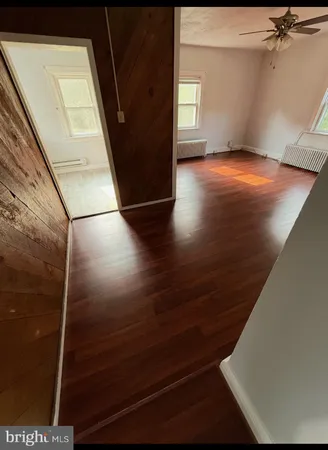 a view of a room with wooden floor and staircase