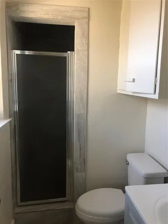 a white toilet sitting next to a bathroom sink