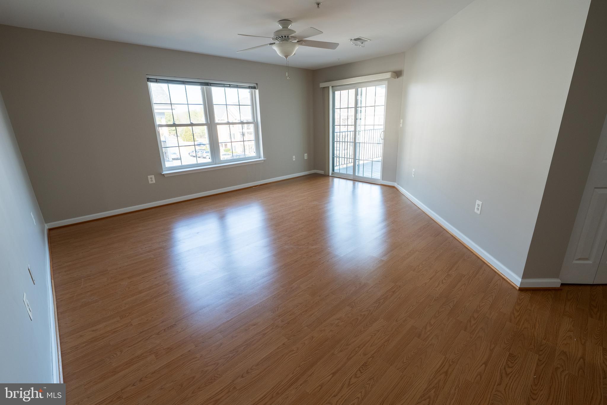 6506 Ridenour Way East, Unit 3A Eldersburg, MD 21784 - Photo 2 of 24 an empty room with wooden floor and windows