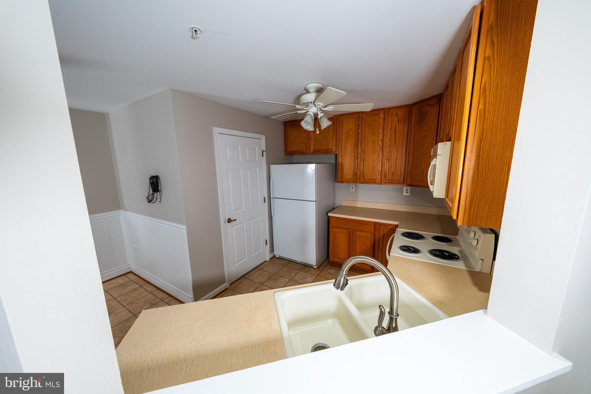 6506 Ridenour Way East, Unit 3A Eldersburg, MD 21784 - Photo 5 of 24 a kitchen with stainless steel appliances granite countertop a refrigerator and a sink