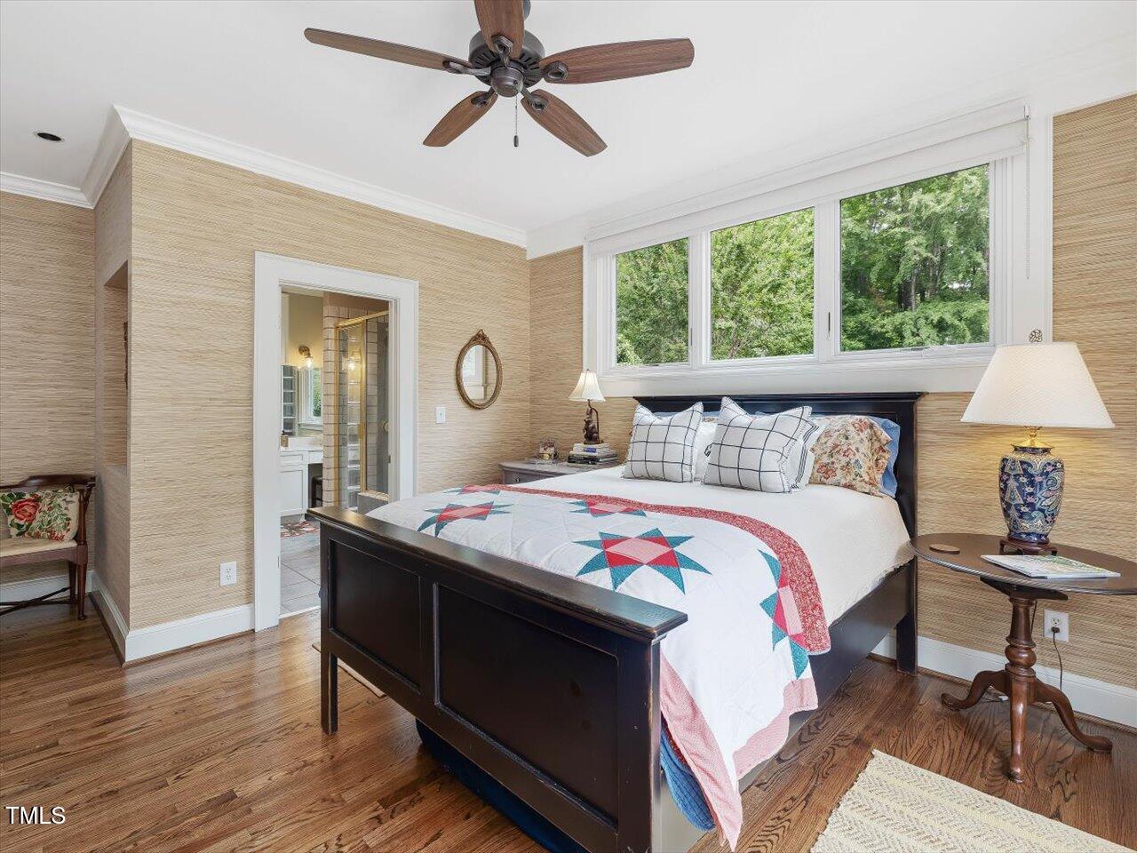 1624 Hopkins Road Bahama, NC 27503 - Photo 32 of 100 a bedroom with a bed a table and a large mirror next to a window
