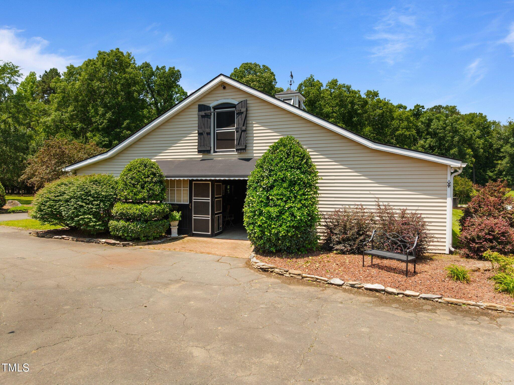 1624 Hopkins Road Bahama, NC 27503 - Photo 60 of 100 a view of a house with a yard and potted plants