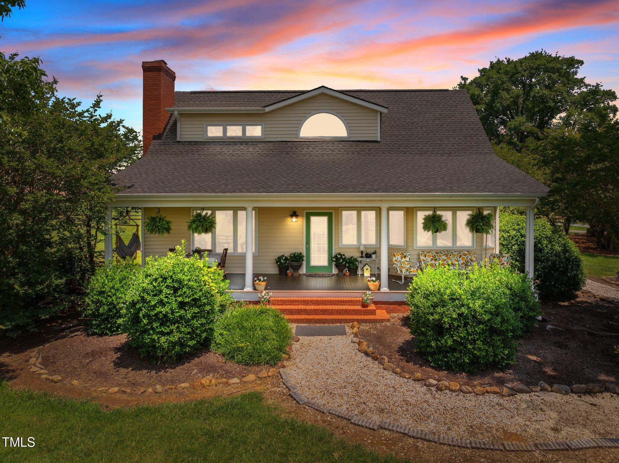 1624 Hopkins Road Bahama, NC 27503 - Photo 80 of 100 a front view of a house with garden