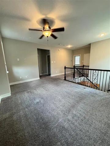 a view of a livingroom with a ceiling fan and window