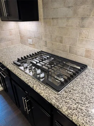 a close view of a stove a faucet and a sink in a kitchen