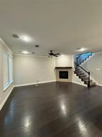 a view of a livingroom with furniture hardwood floor and a ceiling fan