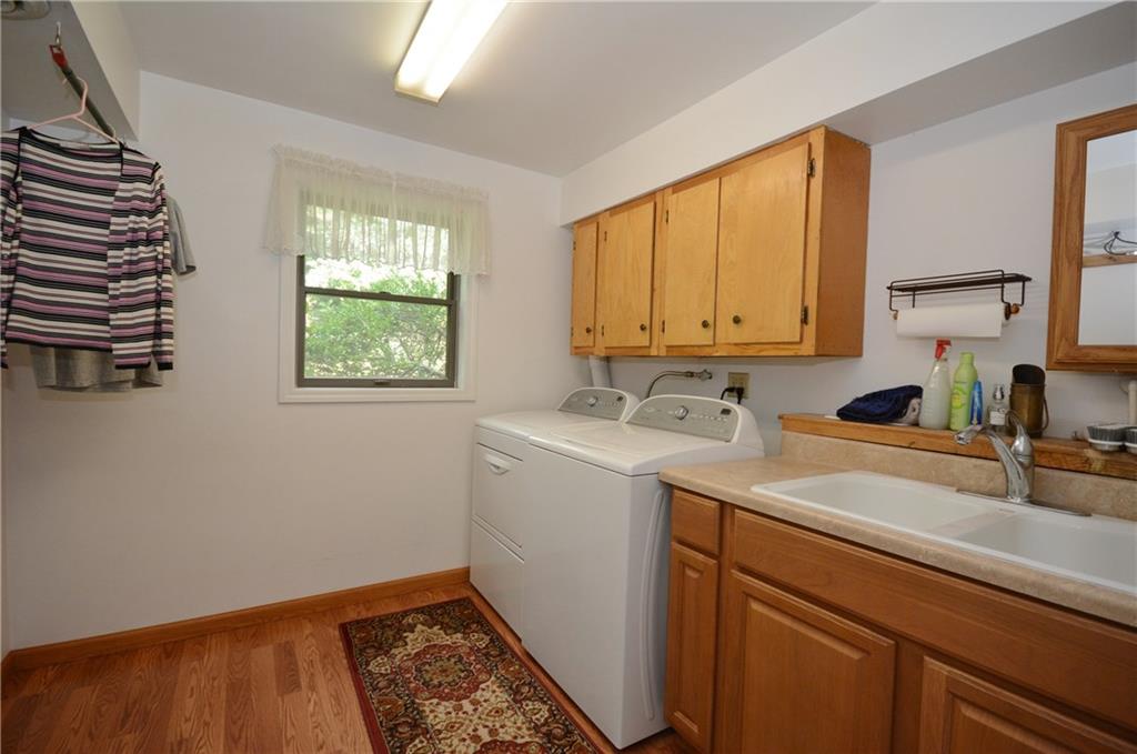 136 Buss Road Aliquippa, PA 15001 - Photo 17 of 25 Laundry room that is stunning and perfect with hanging bar, cabinetry, and double sink.