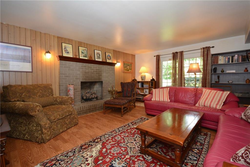 136 Buss Road Aliquippa, PA 15001 - Photo 5 of 25 Cozy Family Room with laminate wood flooring and gas log fireplace.