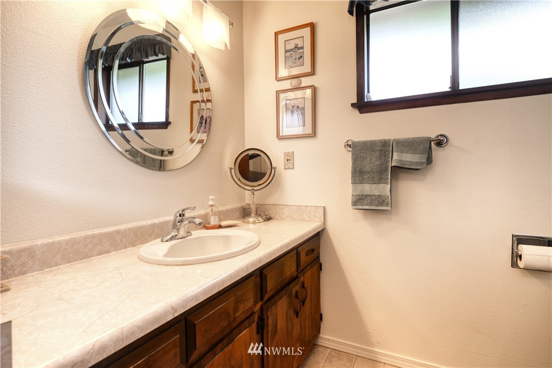 542 Boundary Bay Road Point Roberts, WA 98281 - Photo 13 of 23 a bathroom with a sink a mirror and vanity
