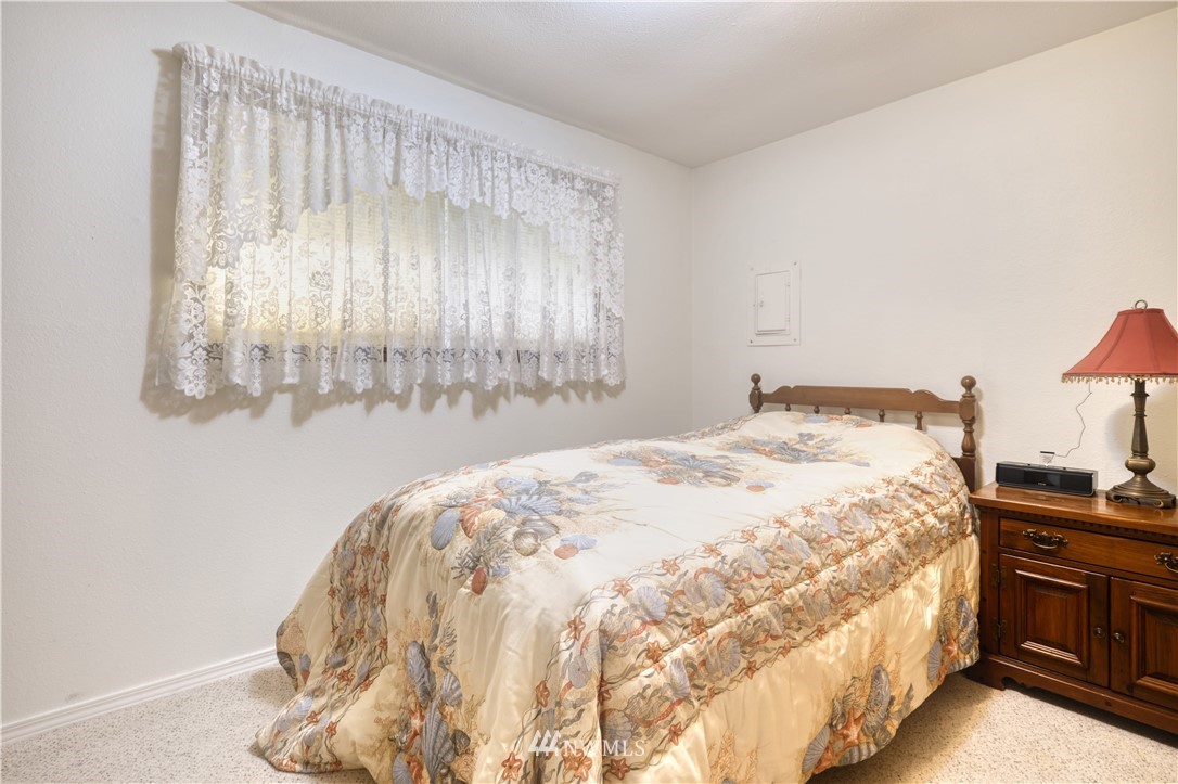 542 Boundary Bay Road Point Roberts, WA 98281 - Photo 9 of 23 a large bed sitting in a bedroom next to a window