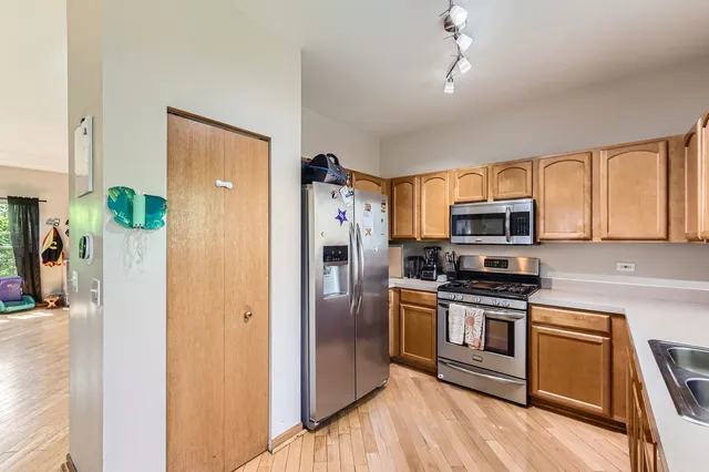 a kitchen with stainless steel appliances a refrigerator stove and microwave