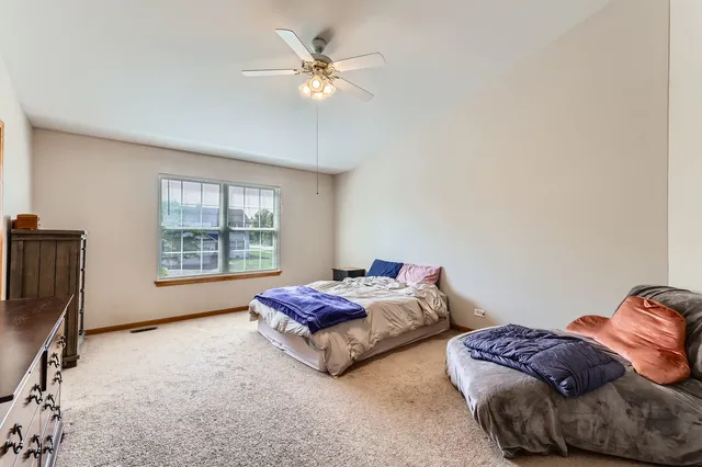 a spacious bedroom with two beds and a chandelier