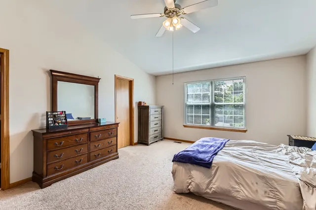 a bedroom with a bed and a dresser
