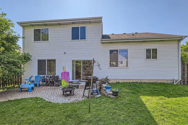 a view of a house with backyard sitting area and garden