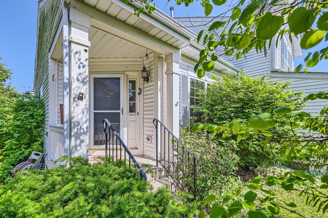front view of a house with a tree