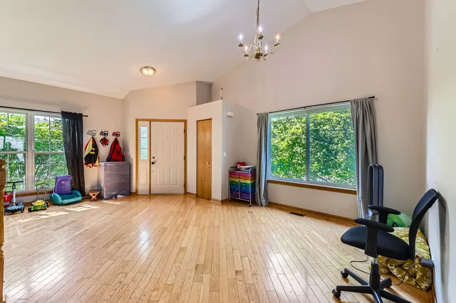 a view of a room with furniture wooden floor and windows
