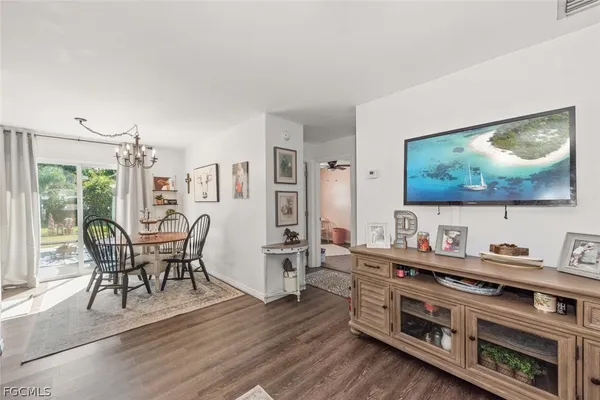 a dining room with furniture and wooden floor
