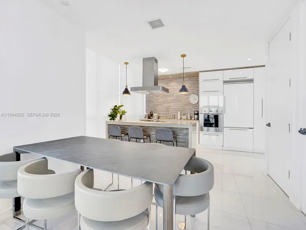 a living room with furniture and kitchen view