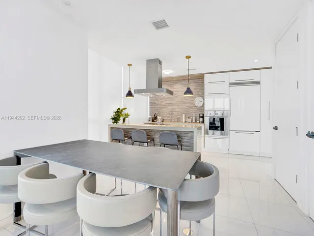a living room with furniture and kitchen view