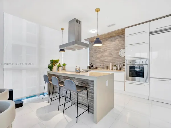 a kitchen with stainless steel appliances kitchen island granite countertop a sink and cabinets