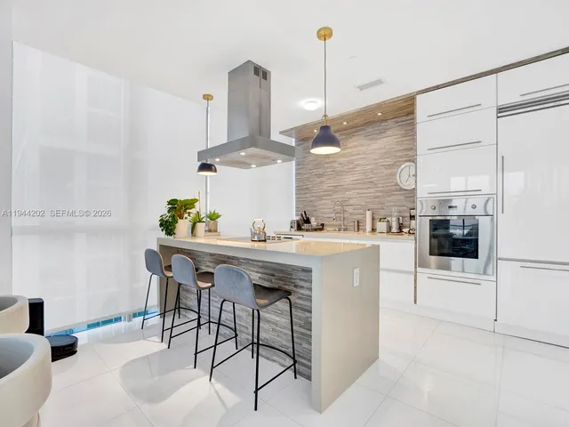 a kitchen with stainless steel appliances kitchen island granite countertop a sink and cabinets