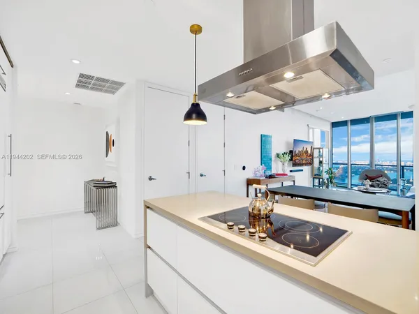 a room with furniture and a view of kitchen