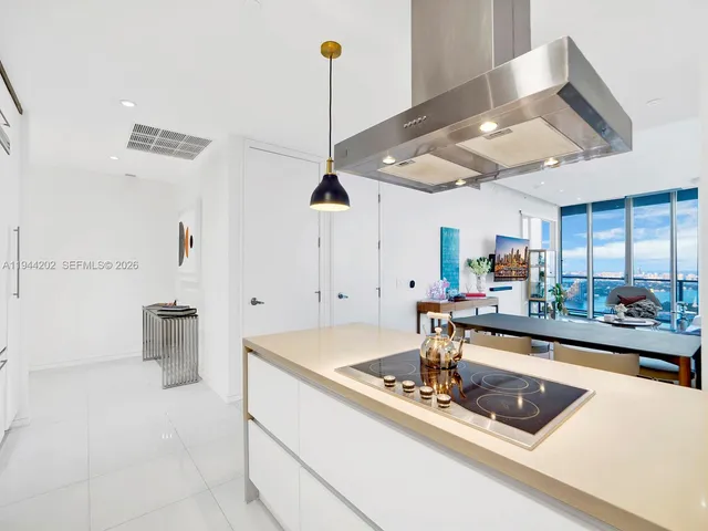 a room with furniture and a view of kitchen