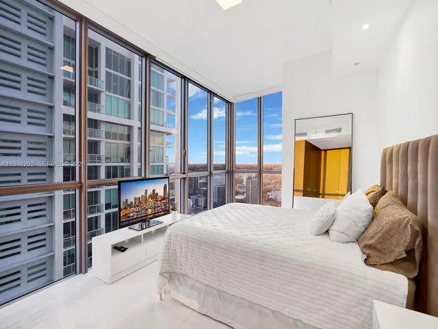 a large bedroom with a large bed and a window