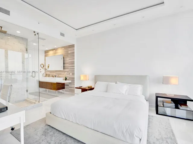 a bedroom with double bed and a large window