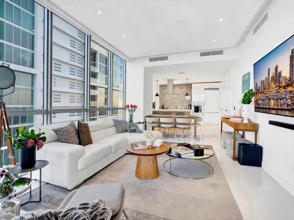 a living room with furniture and a potted plant