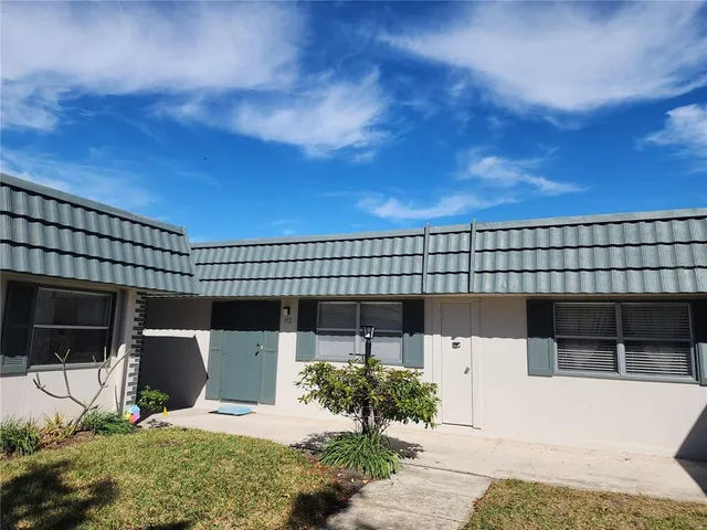 a view of a patio with a table and chairs and potted plants