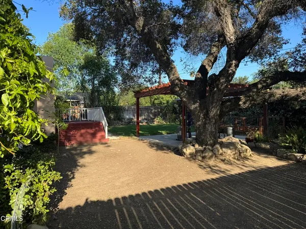 a view of a swimming pool with sitting area and garden
