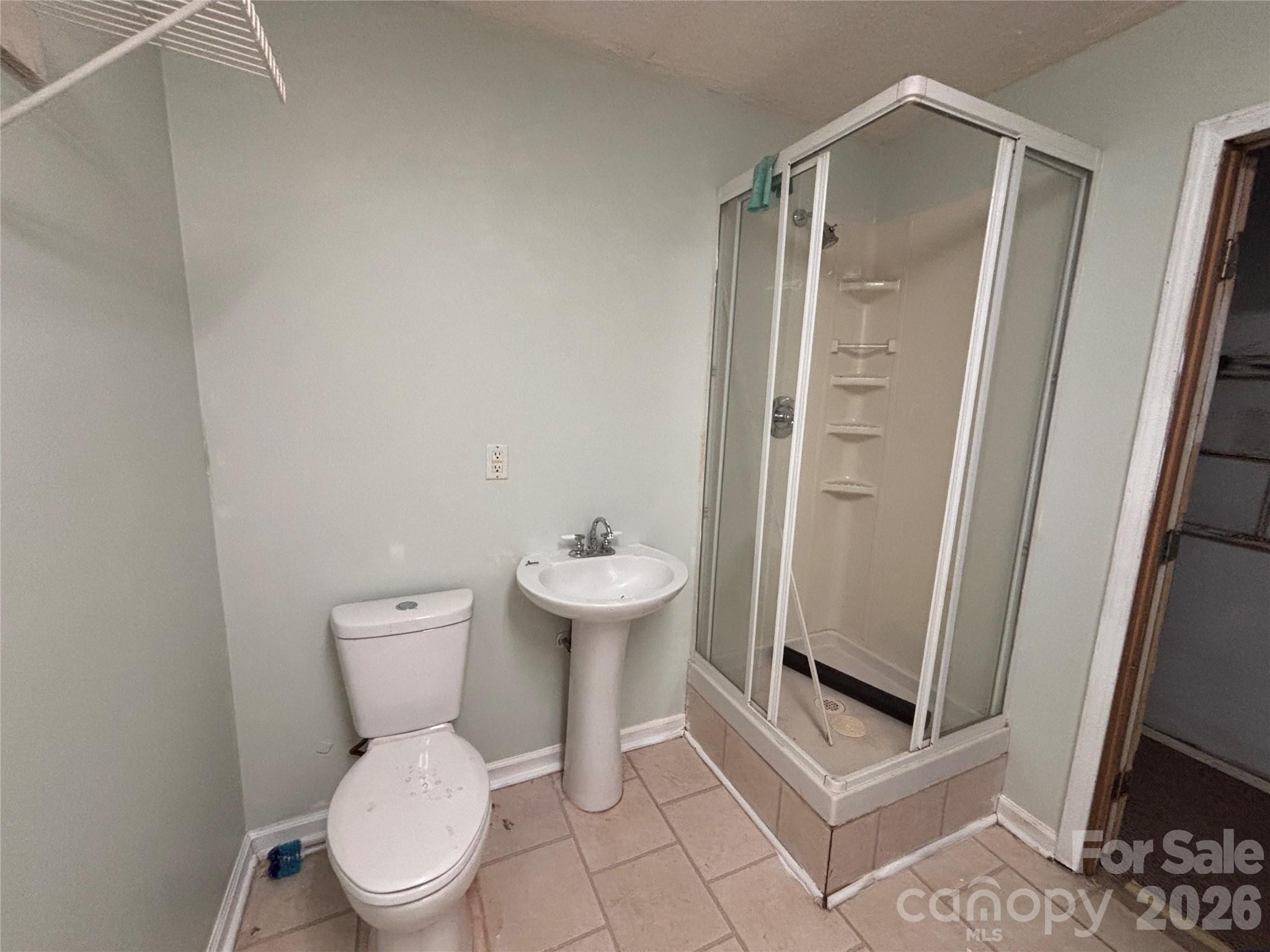5164 Ralph Winchester Road Lenoir, NC 28645 - Photo 14 of 20 a white toilet sitting next to a bathroom sink