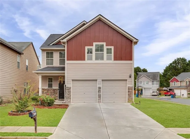 a front view of a house with a yard and garage