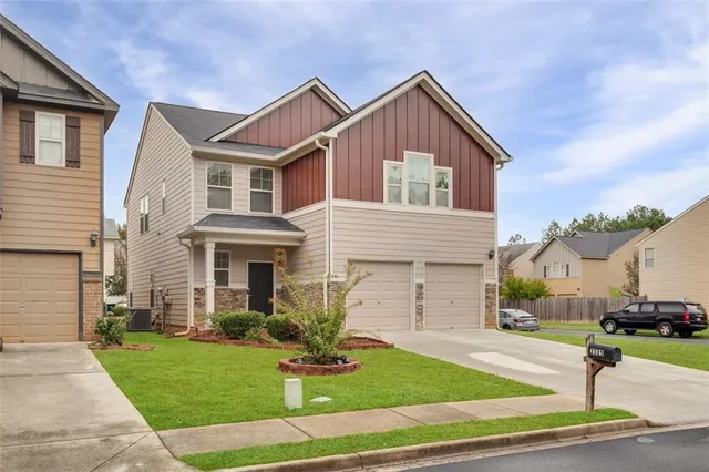 a front view of a house with a yard