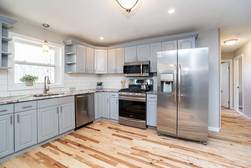 a kitchen with stainless steel appliances cabinets a sink and a window
