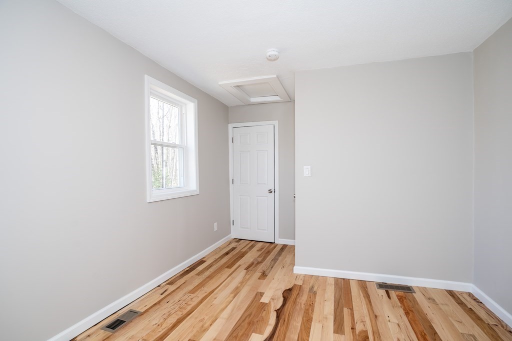 87 McBride Road Wales, MA 01081 - Photo 20 of 36 a view of a room with wooden floor and a window