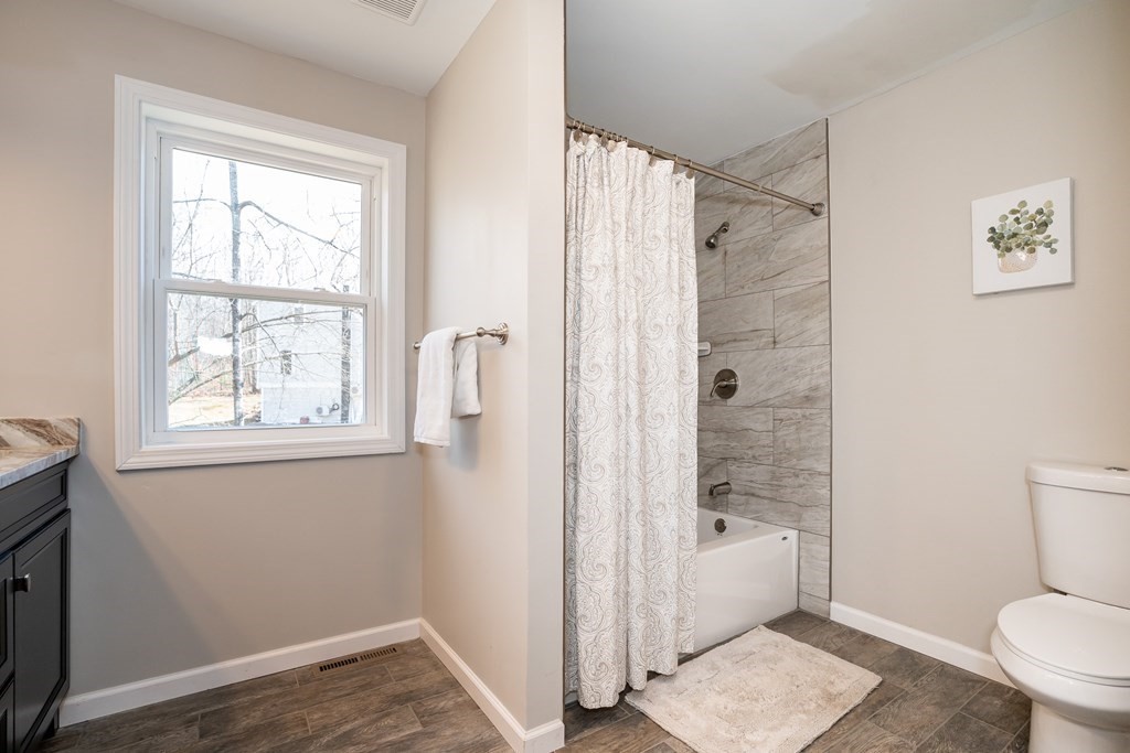 87 McBride Road Wales, MA 01081 - Photo 21 of 36 a bathroom with a shower toilet and a window