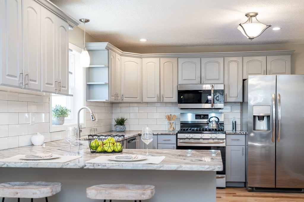 87 McBride Road Wales, MA 01081 - Photo 3 of 36 a kitchen with stainless steel appliances granite countertop a refrigerator a stove a sink and a counter space