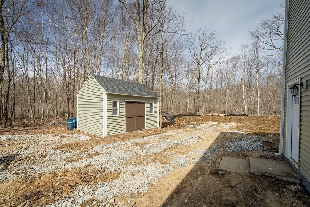 87 McBride Road Wales, MA 01081 - Photo 33 of 36 a view of a house with backyard and tree
