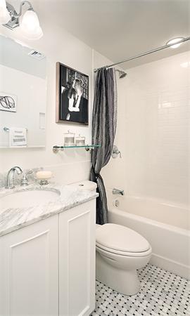 20 Chapel Street, Unit A308 Brookline, MA 02446 - Photo 2 of 5 a bathroom with a granite countertop toilet sink and mirror