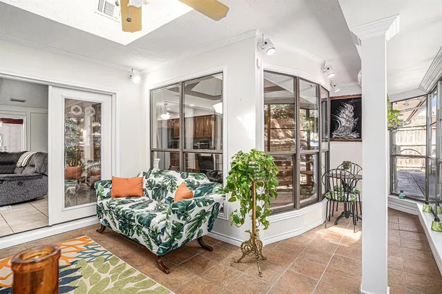 a spacious bedroom with a bed and a chandelier