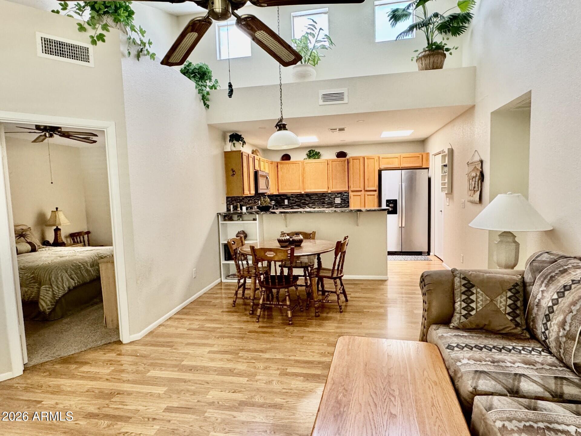 14300 West Bell Road, Unit 211 Surprise, AZ 85374 - Photo 4 of 15 Living_Dining_Kitchen_Sky Windows