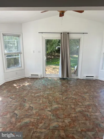 a view of an empty room with windows