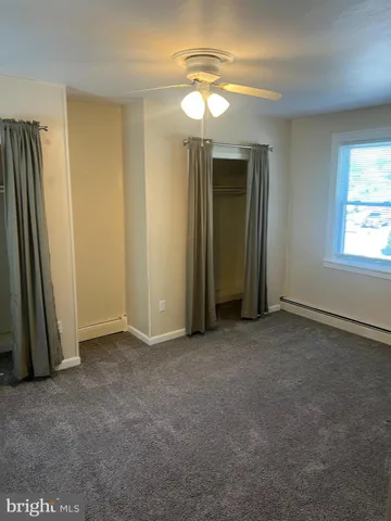 an empty room with closet and a mirror