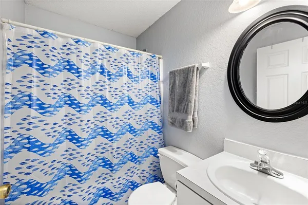 a bathroom with a sink toilet and a mirror