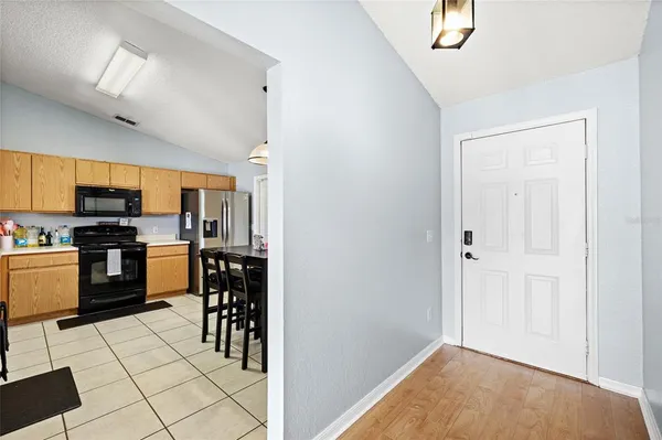 a kitchen with stainless steel appliances kitchen island granite countertop a refrigerator and a stove top oven