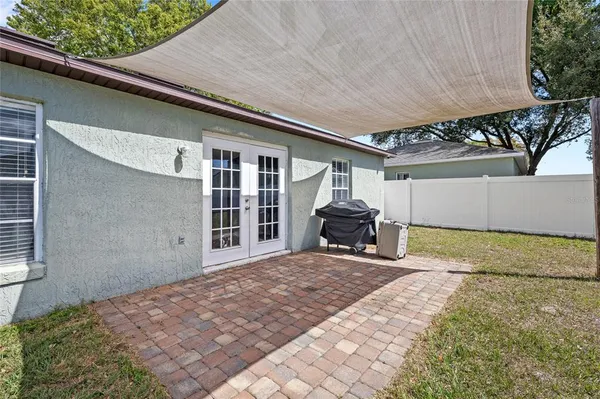 a view of a house with backyard and sitting area