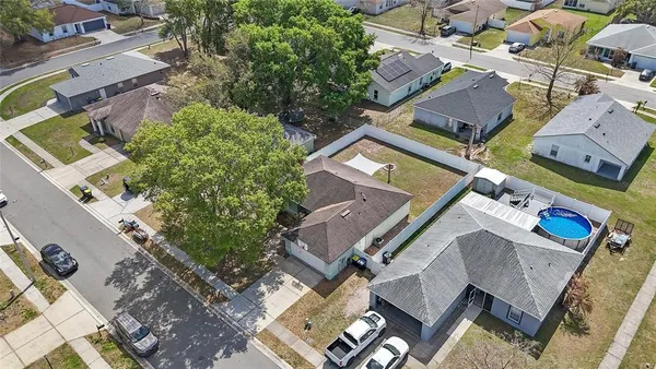 an aerial view of residential house with outdoor space and parking