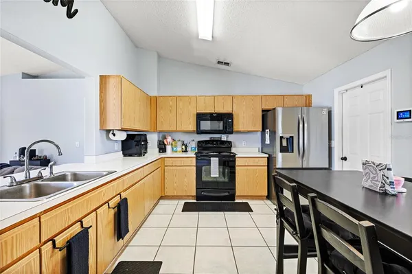 a kitchen with a sink appliances and cabinets